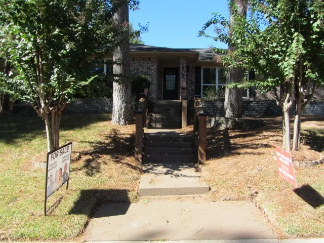 a view of a house with snow on the road