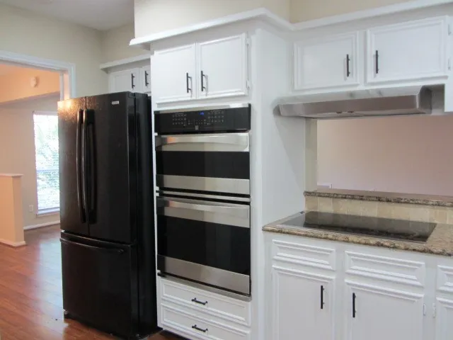 a kitchen with appliances and cabinets