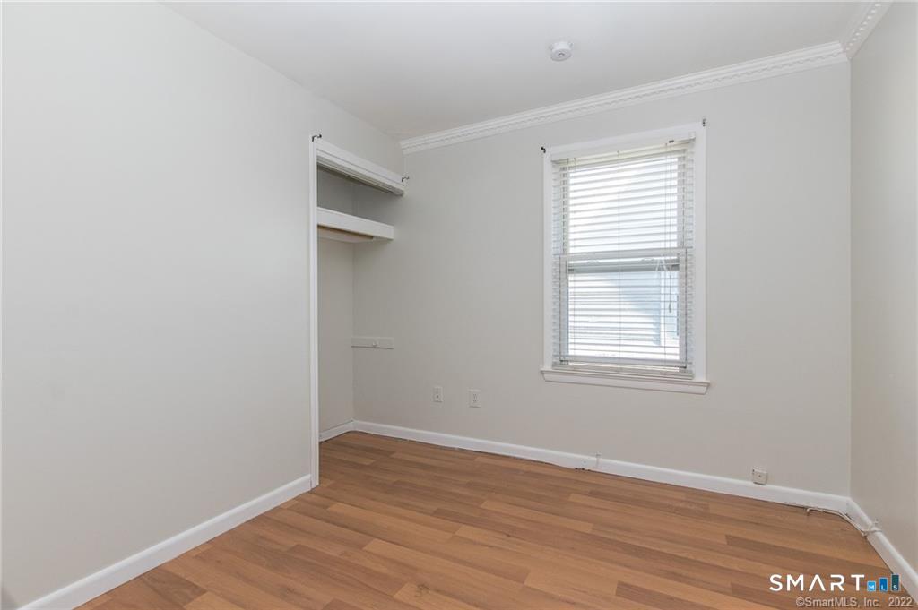 18 Lawrence Street Norwalk, CT 06854 - Photo 23 of 31 an empty room with wooden floor and windows