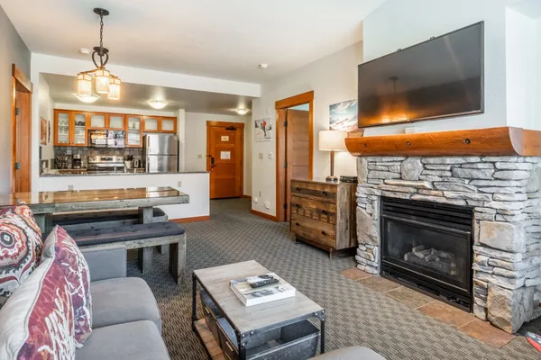 a living room with furniture a flat screen tv and a fireplace