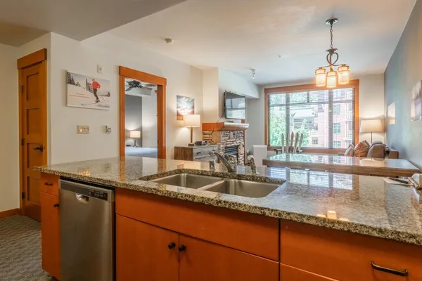 a kitchen with granite countertop a sink and a window