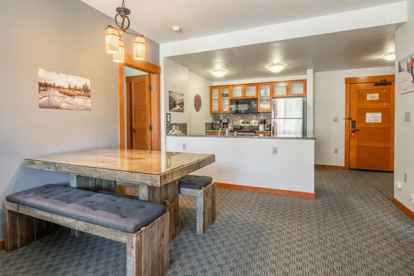 a room with pool table and windows