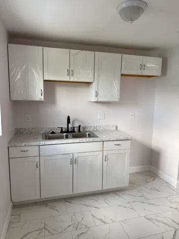 a kitchen with a sink and cabinets