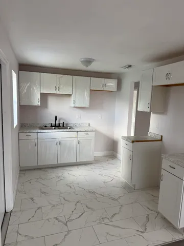 a kitchen with stainless steel appliances a sink and a refrigerator