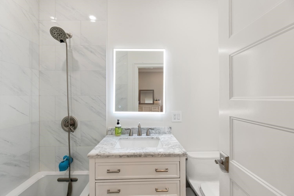 155 Adams Avenue Newton, MA 02465 - Photo 28 of 37 a bathroom with a granite countertop sink toilet and shower
