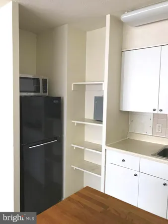 a kitchen with a refrigerator and cabinets