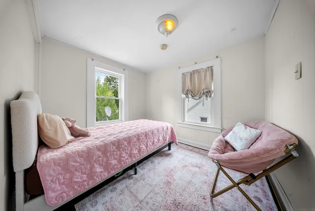 a bedroom with a bed and chair