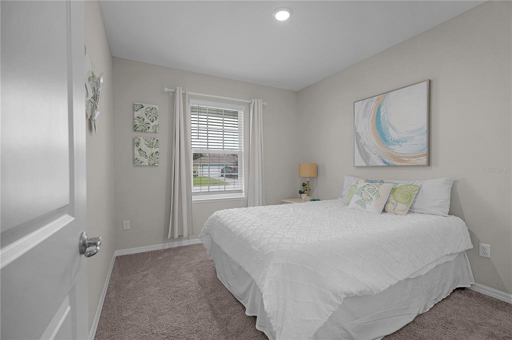 418 Fleming Street Sebastian, FL 32958 - Photo 20 of 38 a bedroom with a bed and a window