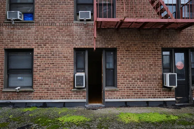 a brick building with a bench and windows