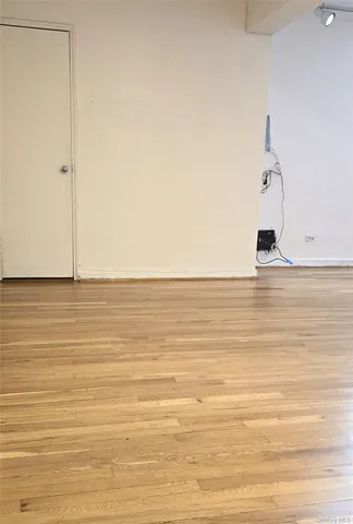 a view of a room with wooden floor