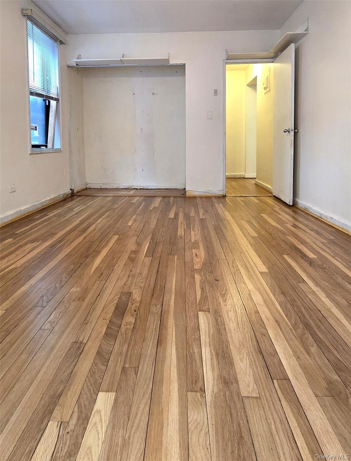 150-11 72nd Road, Unit 1C Queens, NY 11367 - Photo 10 of 25 Unfurnished bedroom with light wood-type flooring