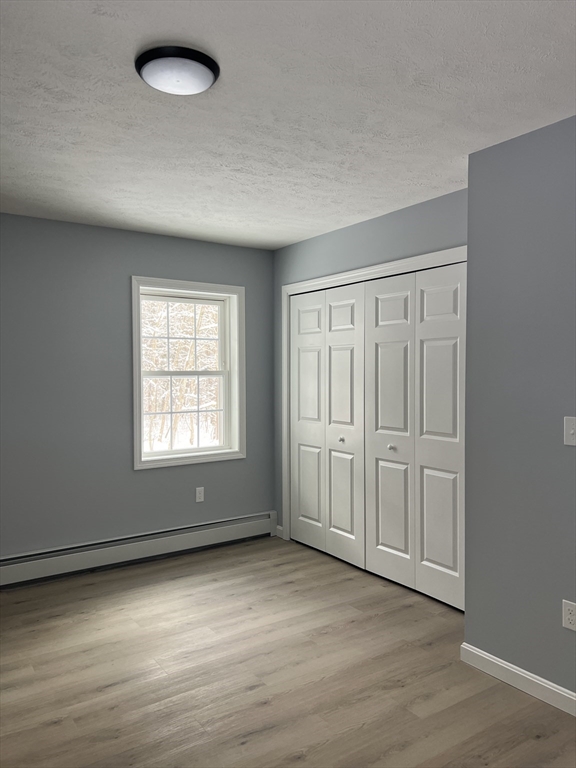 248 Holtshire Road, Unit LOT 2 Orange, MA 01364 - Photo 6 of 12 an empty room with wooden floor and windows