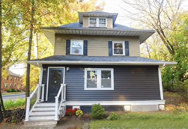 a front view of a house with a garden