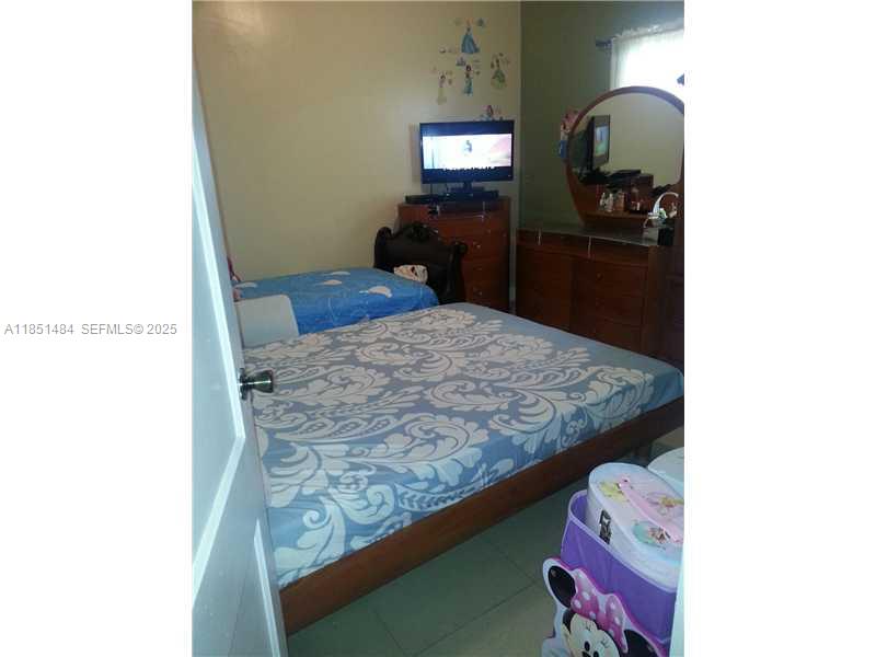 321 Northwest 13th Avenue Miami, FL 33125 - Photo 13 of 13 a bathroom with a granite countertop sink and a mirror