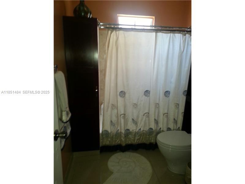 321 Northwest 13th Avenue Miami, FL 33125 - Photo 6 of 13 a bathroom with a toilet and a shower