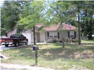 a front view of a house with a yard table and chairs