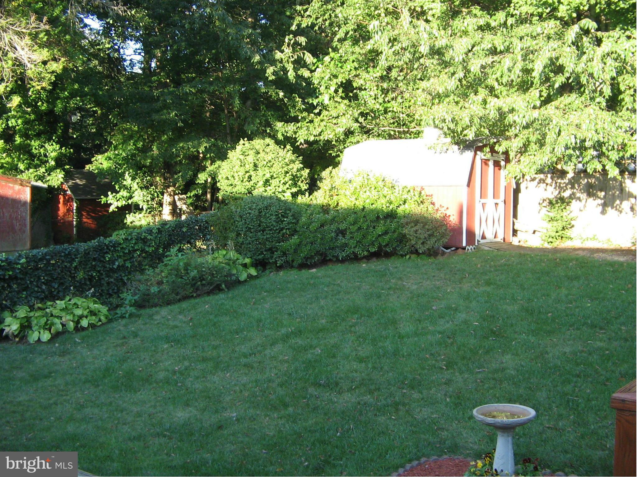 10511 Procter Street Silver Spring, MD 20901 - Photo 13 of 13 a backyard of a house with table and chairs