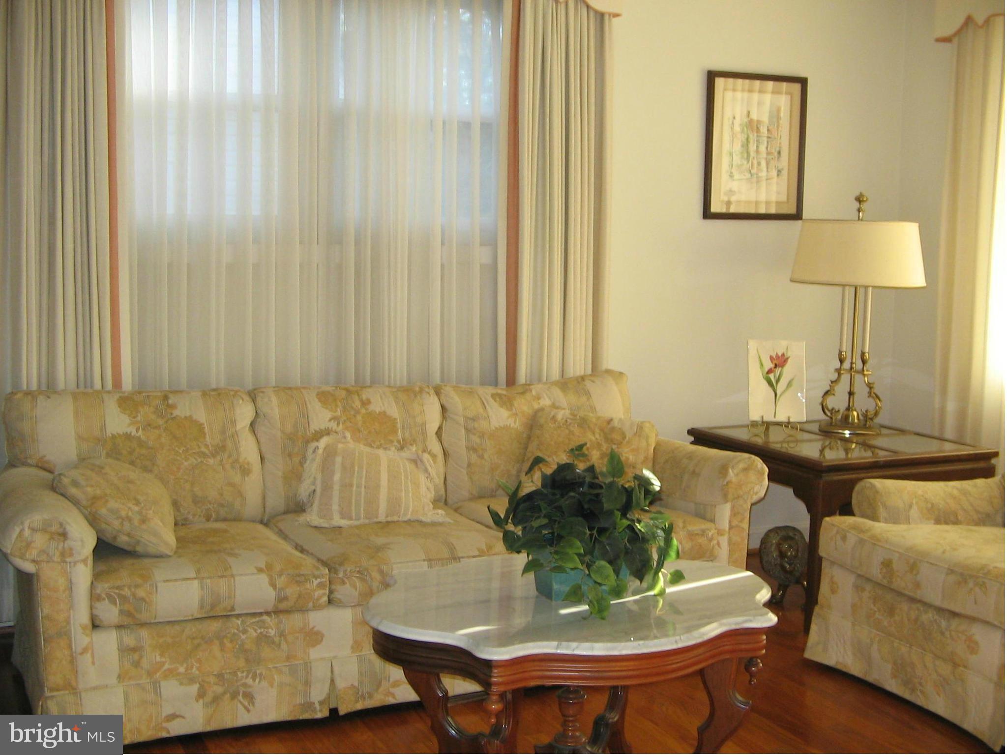 10511 Procter Street Silver Spring, MD 20901 - Photo 3 of 13 a living room with furniture and a lamp