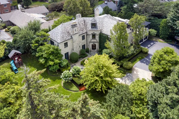 an aerial view of a house with a yard and garden