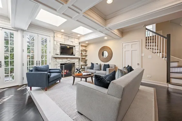 a living room with fireplace furniture and a large window