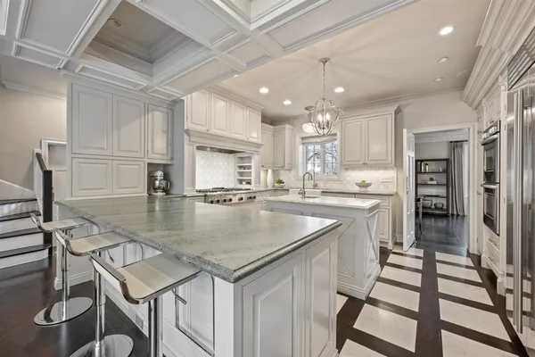 a kitchen with kitchen island a sink table and chairs