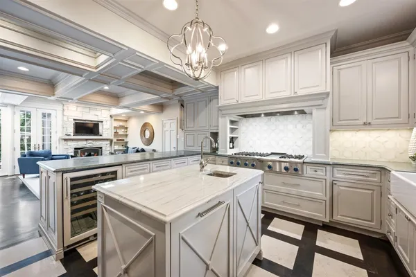 a kitchen with a stove a sink and cabinets
