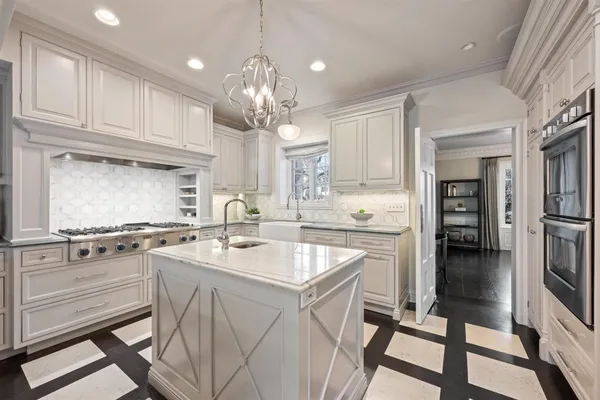 a kitchen with stainless steel appliances granite countertop a stove refrigerator sink and cabinets