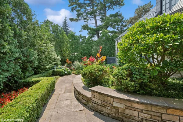 a view of a garden with a building in the background