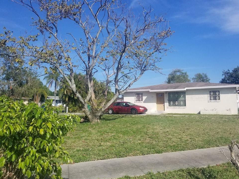 6830 Southwest 23rd Street Miramar, FL 33023 - Photo 13 of 17 front view of a house with a yard