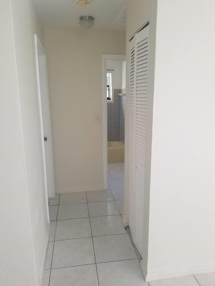 6830 Southwest 23rd Street Miramar, FL 33023 - Photo 16 of 17 a view of hallway with a bathroom and a sink