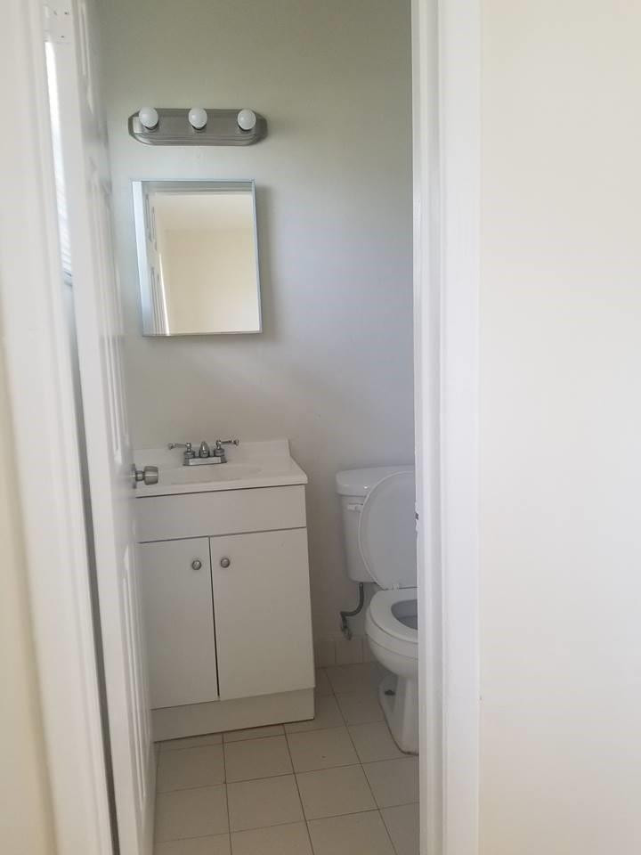 6830 Southwest 23rd Street Miramar, FL 33023 - Photo 8 of 17 a bathroom with a toilet sink and mirror
