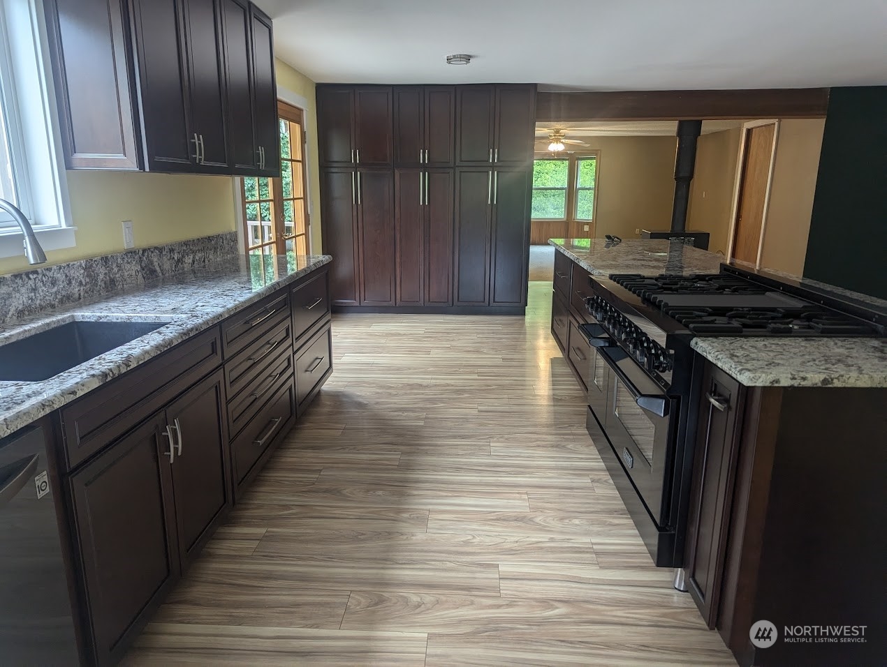 18429 Tualco Road Monroe, WA 98272 - Photo 5 of 5 a kitchen with granite countertop wooden cabinets and a sink