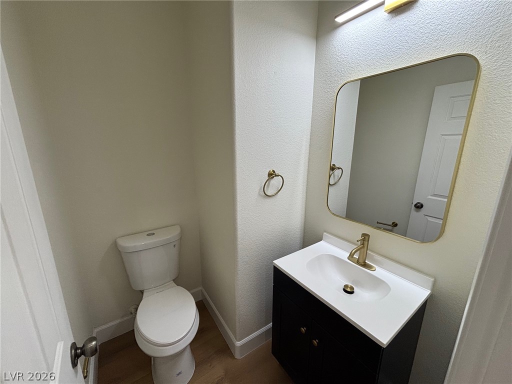 4900 Naff Ridge Drive Las Vegas, NV 89131 - Photo 8 of 21 A compact, efficient lavatory featuring a contemporary vanity and gleaming gold-toned fixtures.