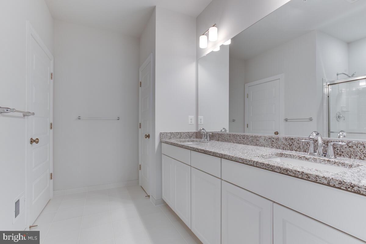 5814 Savannah Drive Brandywine, MD 20613 - Photo 31 of 49 a bathroom with a granite countertop sink and a mirror