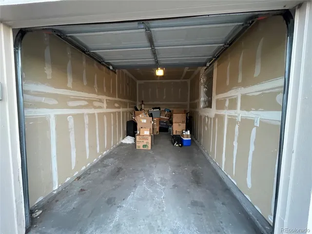 a front view of a house with a yard and potted plants