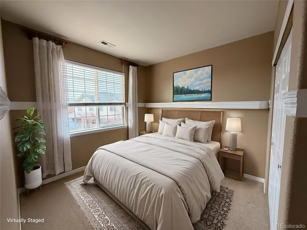 a bedroom with a large bed and a window