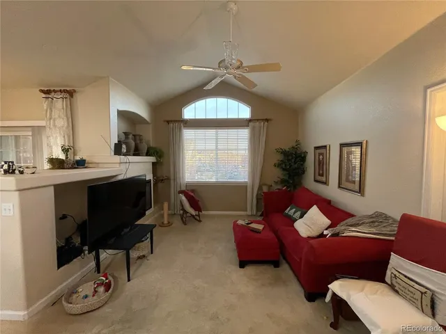 a view of a dining room with furniture and a chandelier