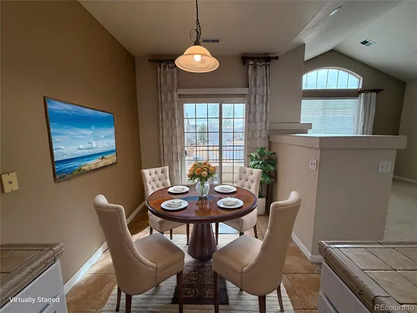 a view of a dining room with furniture and window