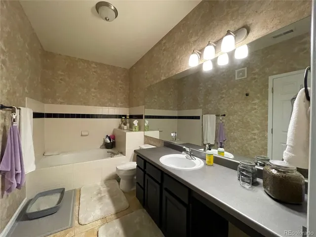 a bedroom with a bed and a table in it