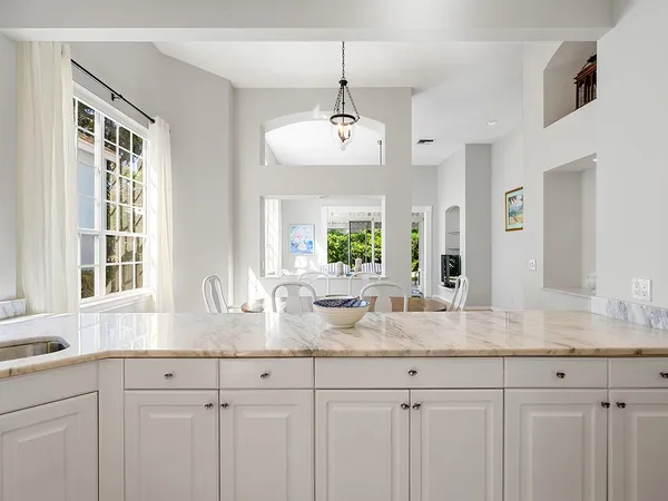 a kitchen with a refrigerator and a stove top oven