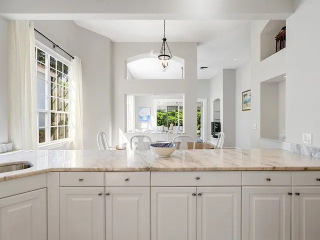 a kitchen with a refrigerator and a stove top oven