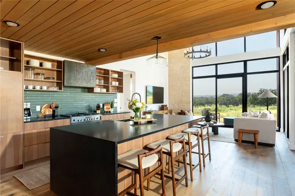 a kitchen with stainless steel appliances granite countertop sink stove and wooden cabinets