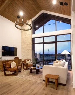 a living room with furniture and a chandelier