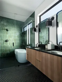 a white bath tub sitting next to a shower