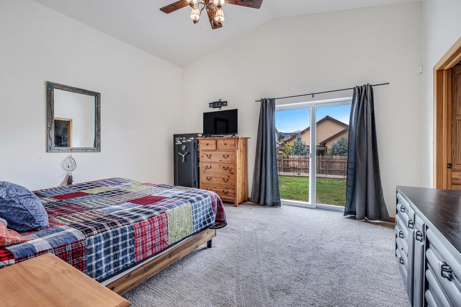 1197 East 18th Way Rifle, CO 81650 - Photo 12 of 19 a spacious bedroom with a bed a dresser and a large window