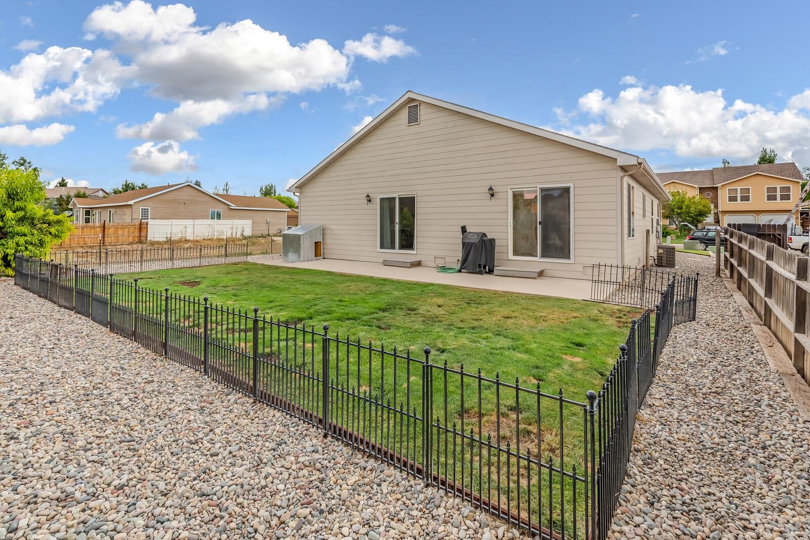 1197 East 18th Way Rifle, CO 81650 - Photo 18 of 19 a view of a house with backyard and sitting area