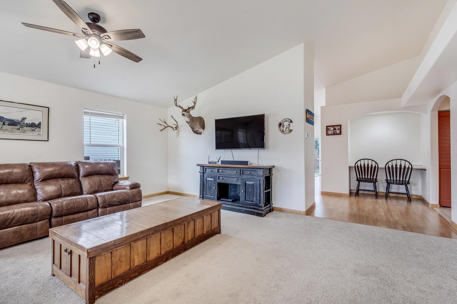 1197 East 18th Way Rifle, CO 81650 - Photo 3 of 19 a living room with furniture and a flat screen tv