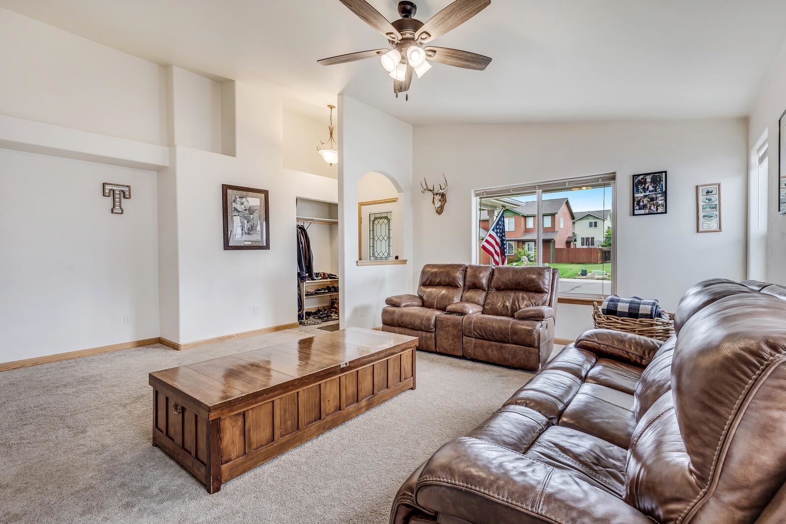1197 East 18th Way Rifle, CO 81650 - Photo 6 of 19 a living room with furniture and a chandelier