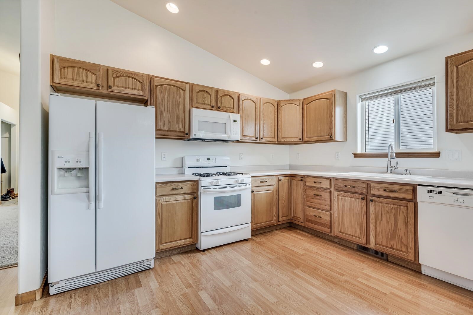1197 East 18th Way Rifle, CO 81650 - Photo 8 of 19 a kitchen with stainless steel appliances granite countertop a refrigerator sink and cabinets