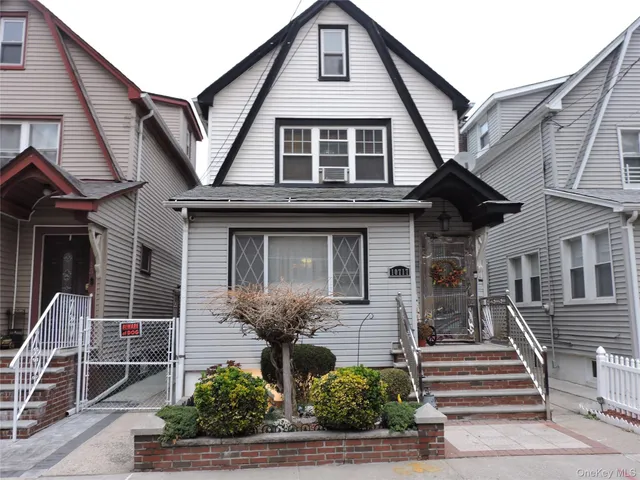 a front view of a house with plants